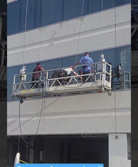Skyworks Unlimited crew working from a suspended swing stage on a building facade