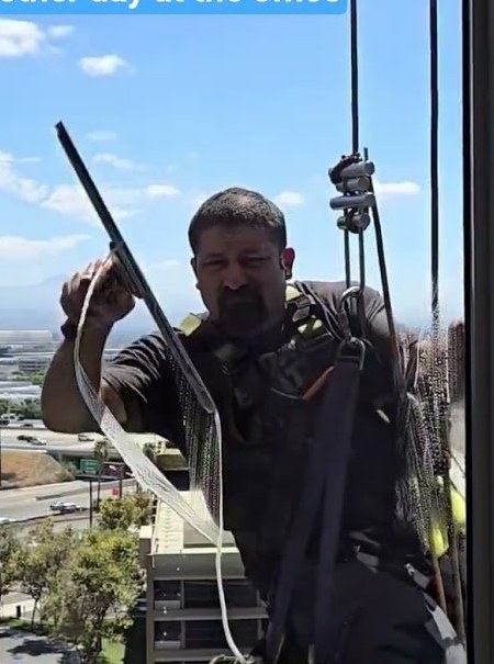Skyworks Unlimited crew setting up at a rooftop rail before a descent